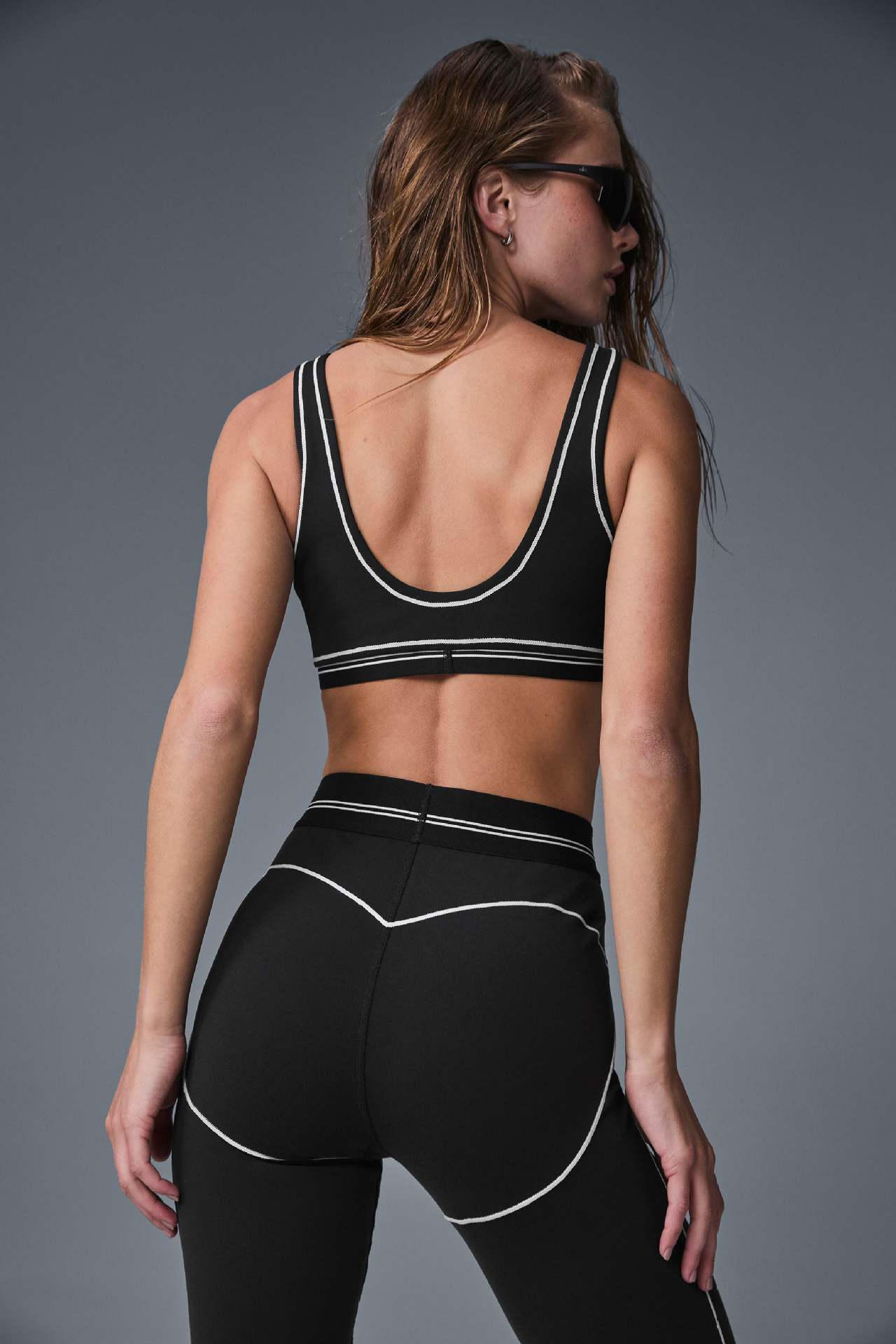 Woman wearing a-l-o Yoga Set with Airbrush Heart Throb Bra for yoga and pilates workouts