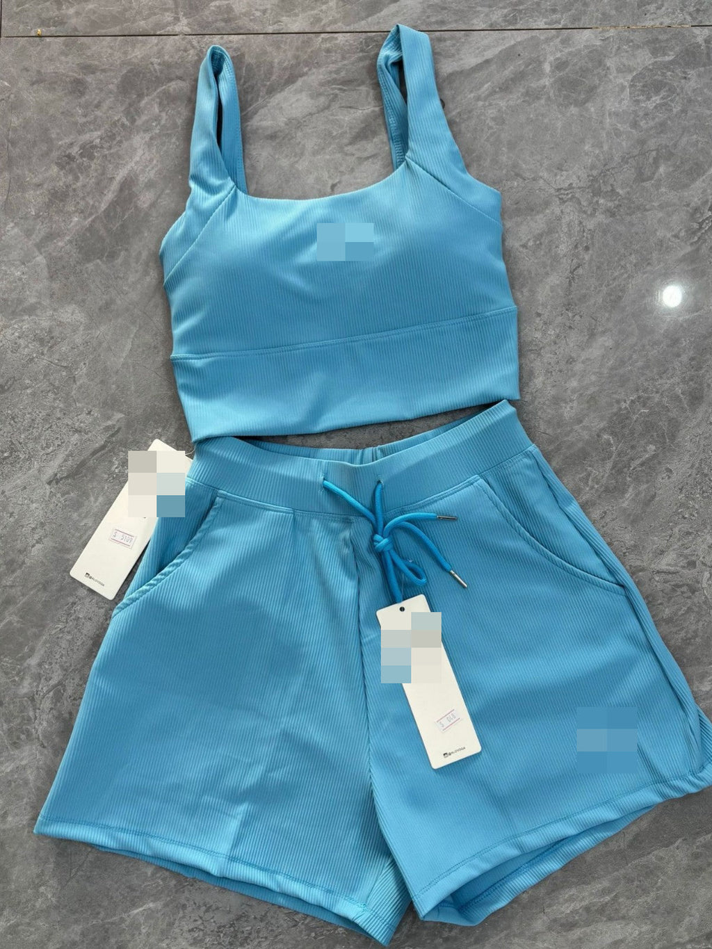 Woman wearing Al Yoga Bra and matching waffle-textured shorts yoga fitness set