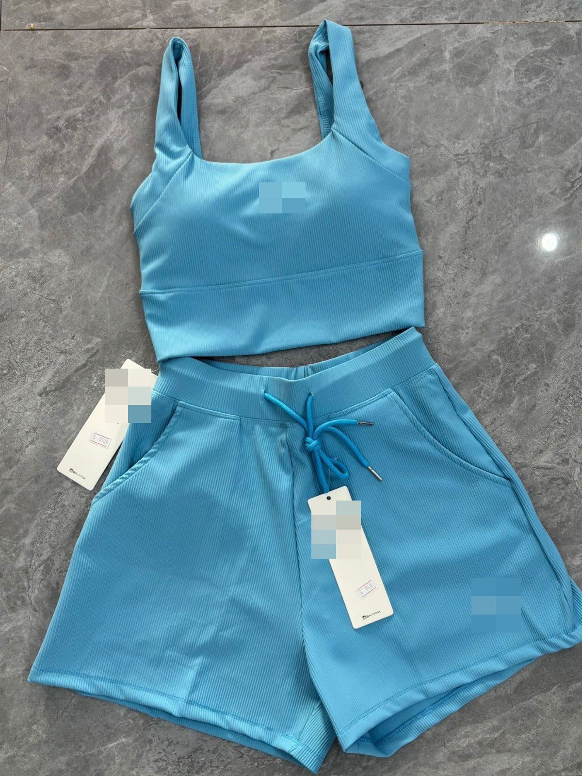 Woman wearing Al Yoga Bra and matching waffle-textured shorts yoga fitness set